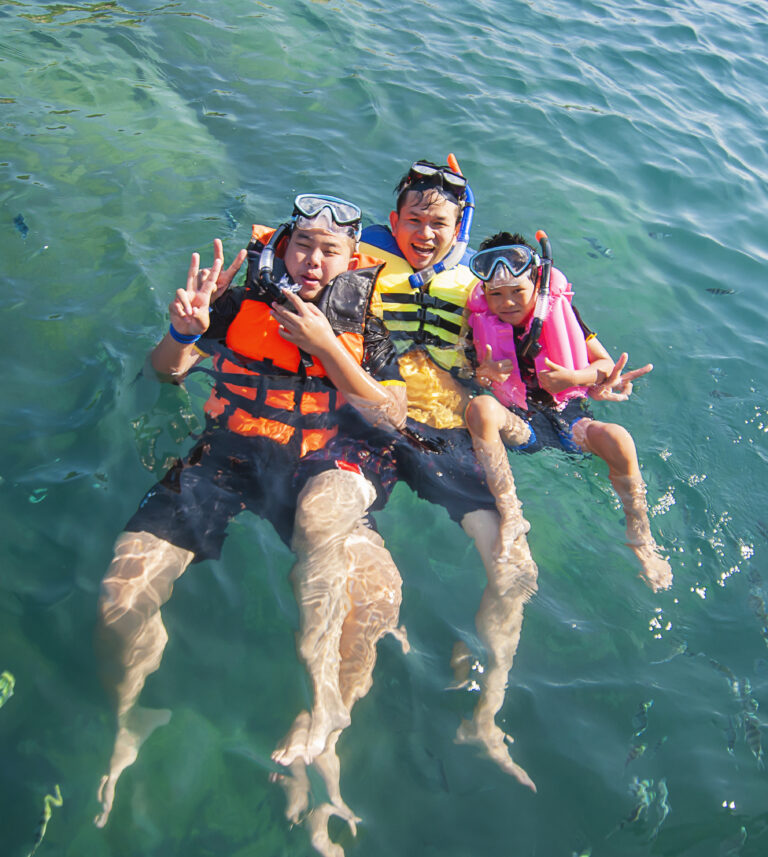 Three guys floating happily in the sea water